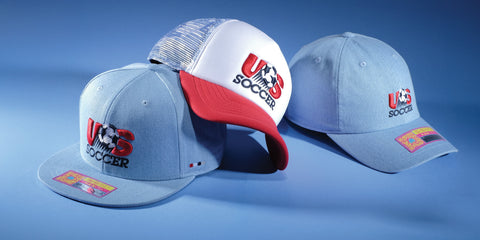 Three US Soccer hats by Fan Ink on a blue background.